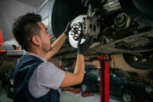istock Latin American mechanic working at a garage checking the car disk brake using protective gloves 1349412691