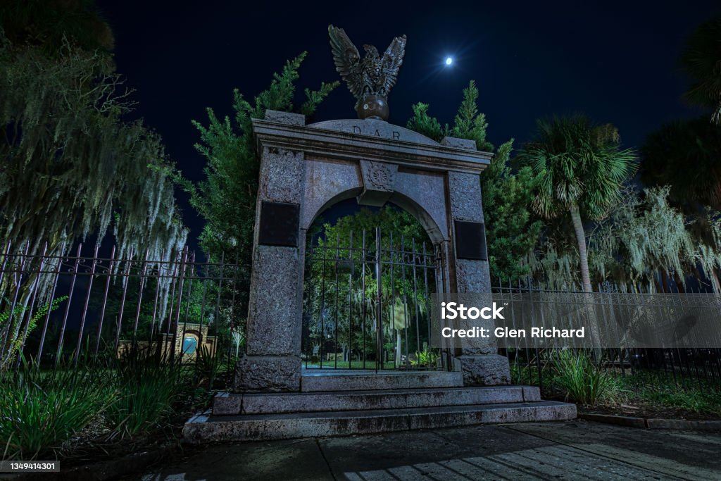Cemetery Gate The gate to a cemetery at night with the moon shining bright. Cemetery Stock Photo