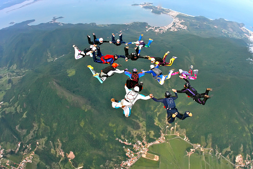 January 26, 2010. São José, Santa Catarina, Brazil. Paratroopers jump in a formation holding hands over the continent.