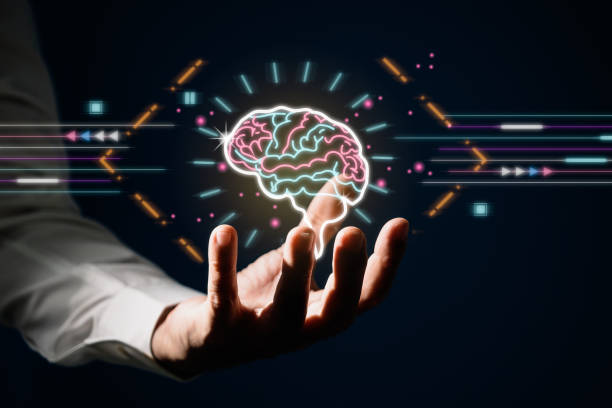 istock Man hold brain graphic with glowing effect as creativity on dark blue background. Idea and knowledge for innovation 1349420090