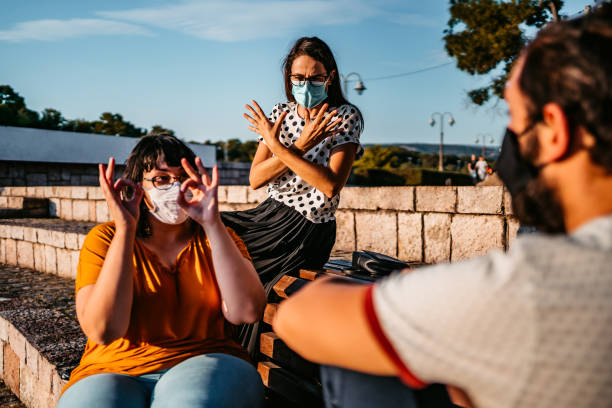 istock Friends speak in sign language 1349420439