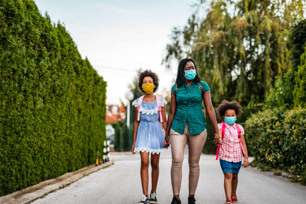istock Mother taking her daughters to school 1349421406
