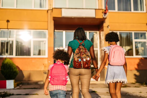 istock Mother taking her daughters to school 1349421423