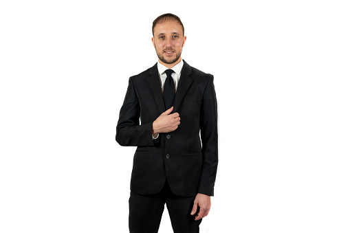 A Caucasian man wearing a suit and posing on a white background