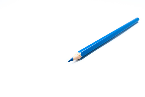 side view of colored pencils blue on a white background concept art design copy space school and office.