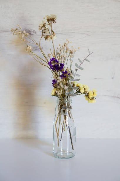 istock Flowers in a vase on a wooden background 1349425672