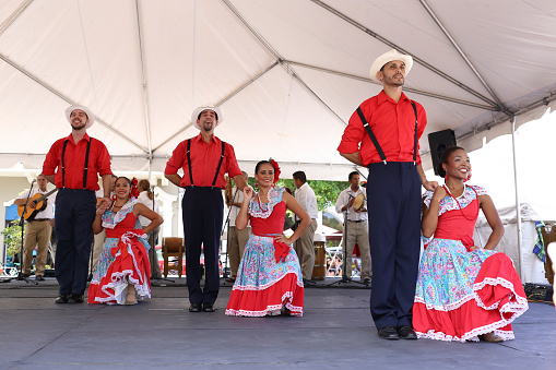 San Juan, Puerto Rico-April 26,2014:Couples dressed in traditional costumes pose after the dance on the stage in the center.