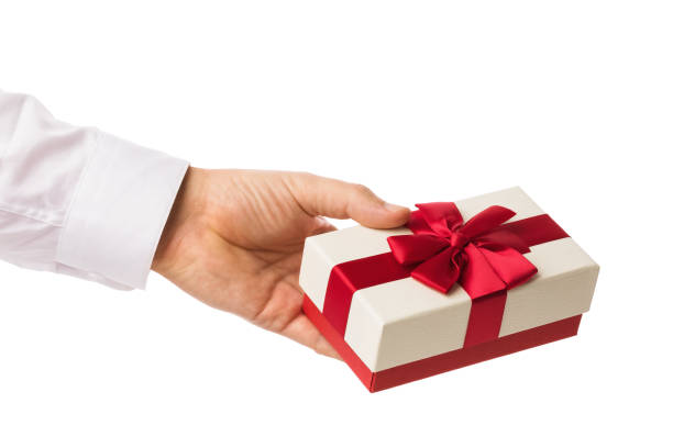 istock Man's hand holding a box with a gift, isolated on white background, template for designers 1349428110