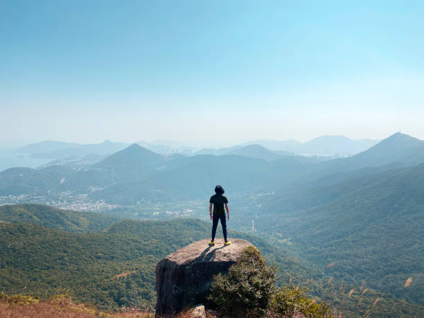 istock Young Man Standing on Rock Over Looking a Scenics Mountain View. 1349428313