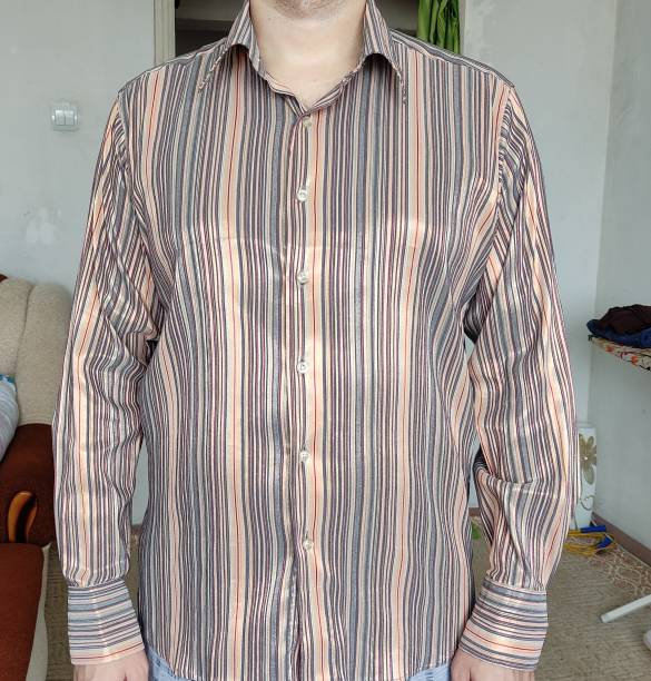 istock Man tries on a shirt at home 1349428789