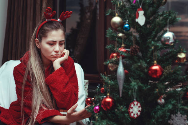 sad young woman alone at christmas - santa hat bildbanksfoton och bilder