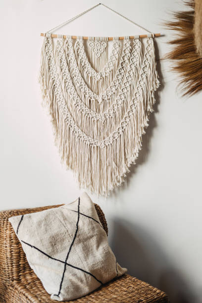 istock Macrame over wicker armchair in white room 1349433350