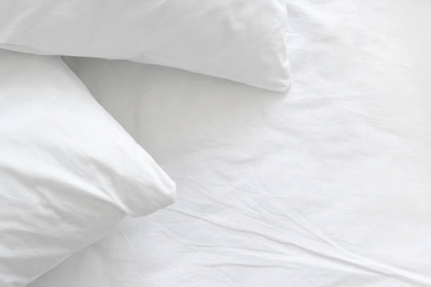 In the close-up shot, luxurious pillows and a bolsters are arranged neatly on the bed, creating a cozy and inviting atmosphere.