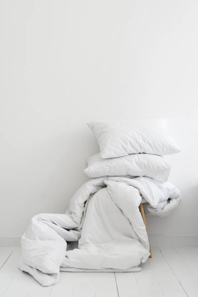 istock White blanket and two pillows on chair 1349433508