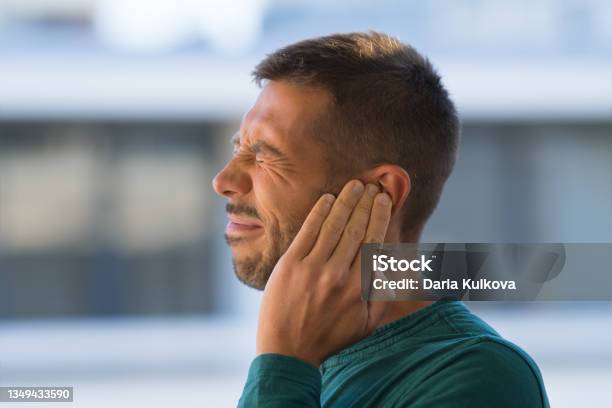 Otitis Or Tinnitus Man Touching His Ear Because Of Strong Earache Or Ear Pain Stock Photo - Download Image Now