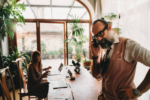 istock Two mid adults business people are working in their office 1349433745
