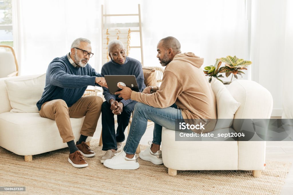 Using tablet to setup smart home for retirement couple peace Home Consultation for senior couple Will - Legal Document Stock Photo