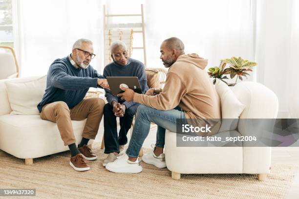 Using Tablet To Setup Smart Home For Retirement Couple Peace Stock Photo - Download Image Now