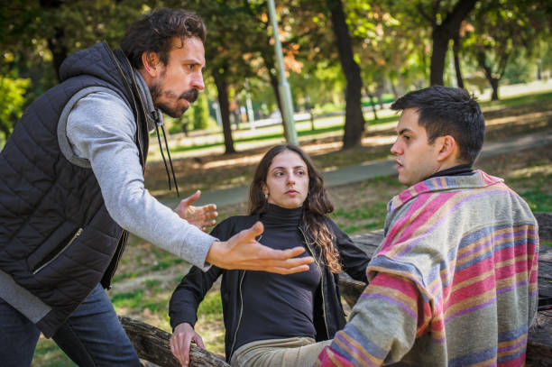 istock Three upset friends in fierce argument. Group quarrel concept 1349437555