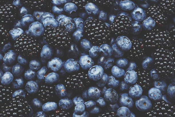 istock Blackberry and  blueberry background. Top view. 1349438597