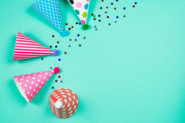 istock Colorful birthday caps on a blue background. Top view. 1349438658