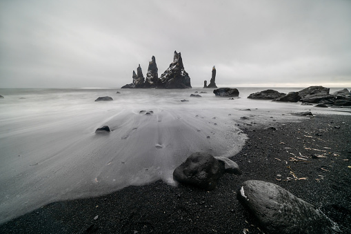 Basalt rock formations Troll toes on black beach. at storm Reynisdrangar, Vik, Iceland.