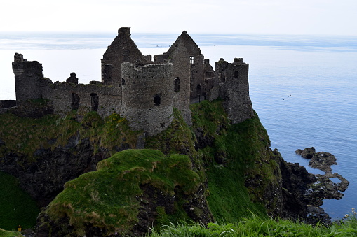 Close up of a castle in Northern Ireland with rocks covered in green moss