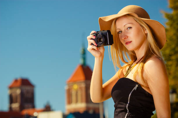 istock Beautiful elegant woman taking pictures with camera 1349443120