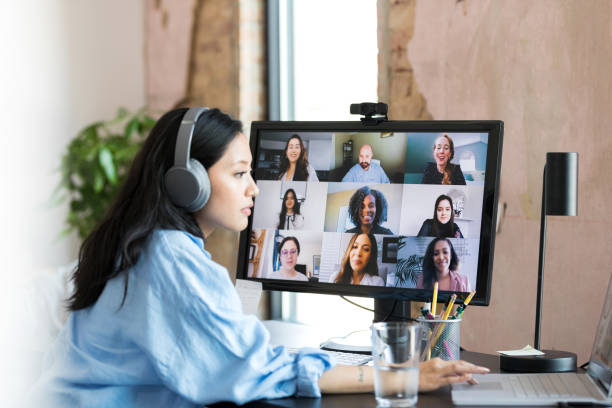 istock Woman uses laptop as co-workers wait in video conference 1349443314