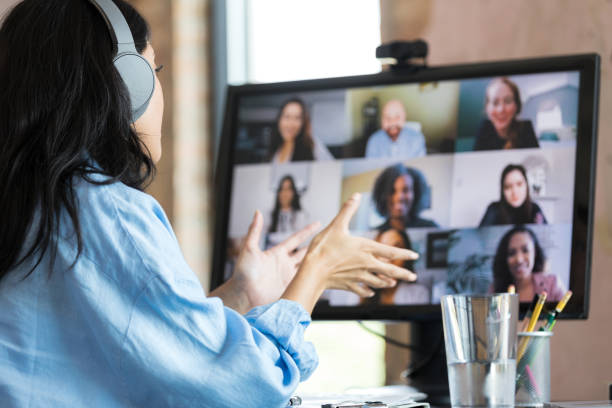 istock Unrecognizable woman gestures during video conference with co-workers 1349443328