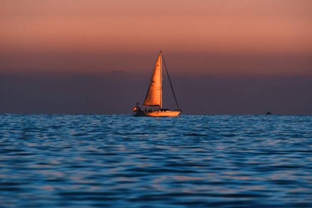 istock boat in the sea at sunset 1349446135