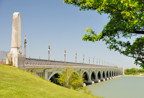 The historic Belle Isle Bridge traverses the Detroit River.