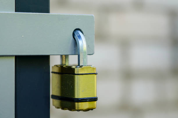 istock locked padlock with yellow body hangs in the door loop 1349454181