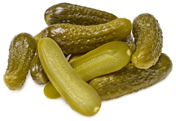 istock marinated pickled cucumbers with slices isolated on white background. Clipping path and full depth of field 1349454604