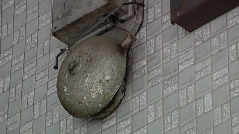 Vintage School Bell on the Wall of a Corridor. Close Up.