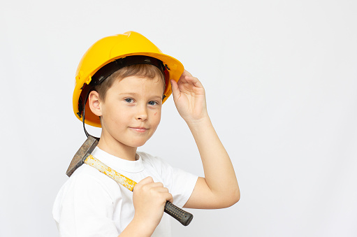young boy construction worker in a hard hat , on a white background