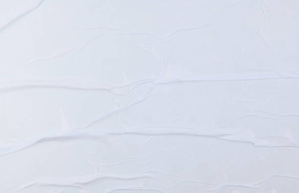 istock Blank white crumpled and creased sticker paper poster texture 1349459696