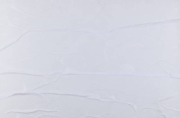 istock Blank white crumpled and creased sticker paper poster texture 1349459762