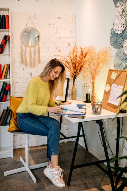 istock Online Stock Trades: Beautiful Woman Working from Home 1349462573