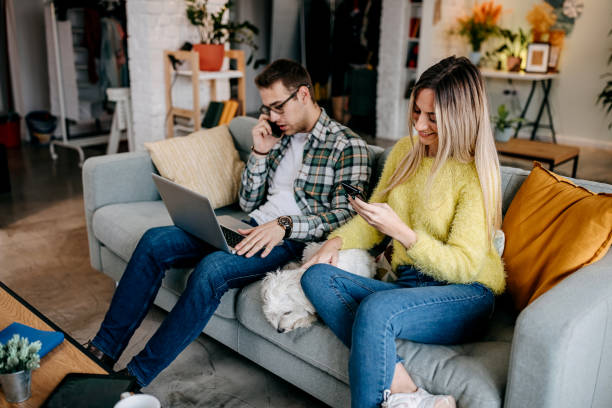 istock Couple with their pet dog at home 1349462913