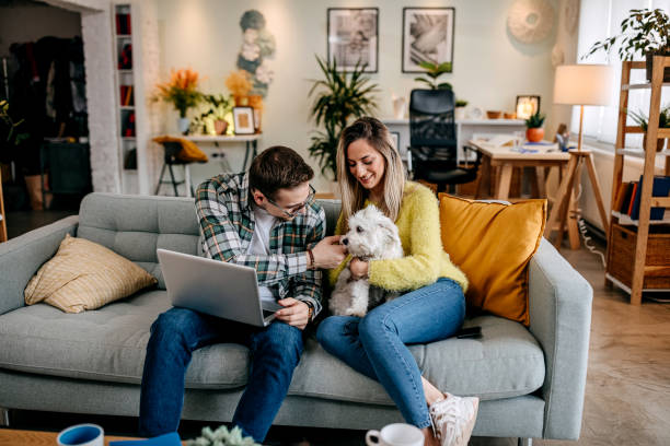 istock Modern couple with their pet dog at home 1349462932
