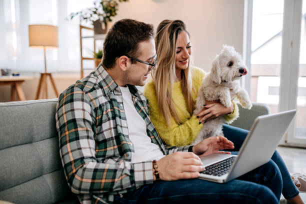 istock Couple with their pet dog at home 1349462949