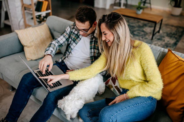 istock Couple with their pet dog at home 1349462952