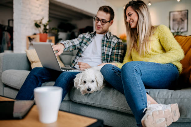 istock Modern couple with their pet dog at home 1349462955