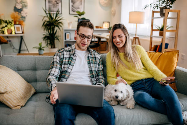 istock Couple with their pet dog at home 1349462980