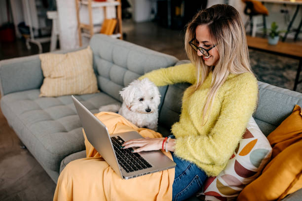 istock Young woman using laptop at home 1349463035