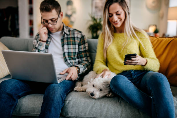 istock Couple with their pet dog at home 1349463092