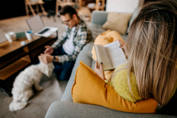 istock Couple with their pet dog at home 1349463801
