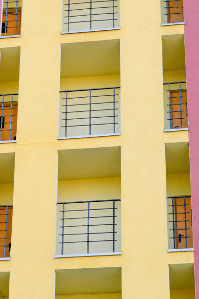 Facade of a residential modern high-rise urban house with beautiful colors on a bright summer sunny day against the blue sky
