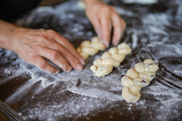 Traditional Christmas Stollen pie is ready for baking in the oven. Making German Christmas bread with raisins and candied fruits . White background. Template for a Christmas pastry recipe